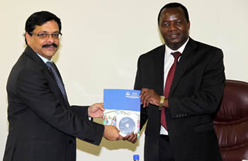 Dr. C Vijayakumar, the Director of International Relations at  VIT University presenting a handbook and multimedia materials about his Institute to HIT Acting Vice Chancellor Eng. Q.C Kanhukamwe.