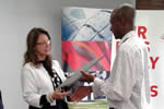 Clive Nyapokoto receiving his award from the Austrian Ambassador to south Africa Ambassador Brigitte Öppinger-Walchshofer