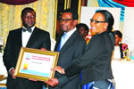 HIT Acting Vice Chancellor Eng Kanhukamwe (Left) accompanied by his wife Mrs R. Kanhukamwe being presented with a LASOF Career and Leadership Legacy Award by the Guest of Honour, Dr Hebert Murerwa (Middle).